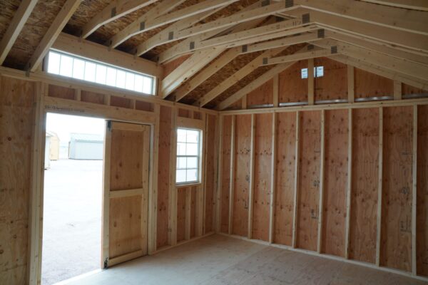 A view from the inside of a 12x16 Studio Gable storage shed, with exposed studs and plywood.