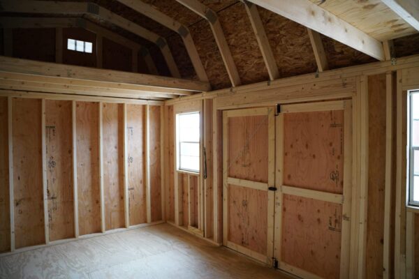Interior view of the 10x16 Barn Style storage shed showing the double doors and windows.