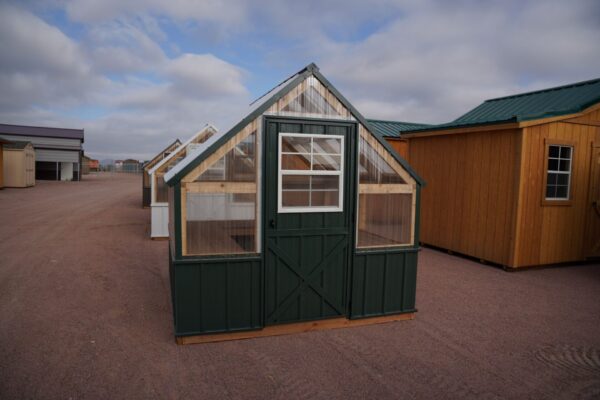 Front view of an 8x8 Green House with wood frame, metal siding, and plastic covering on the upper walls