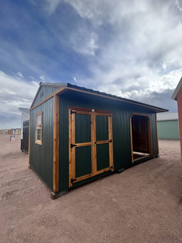 10x20 Loafing Shed with Tackroom large shed with double doors plus a large open entrance and a window. Green walls and wooden trim, metal roof.