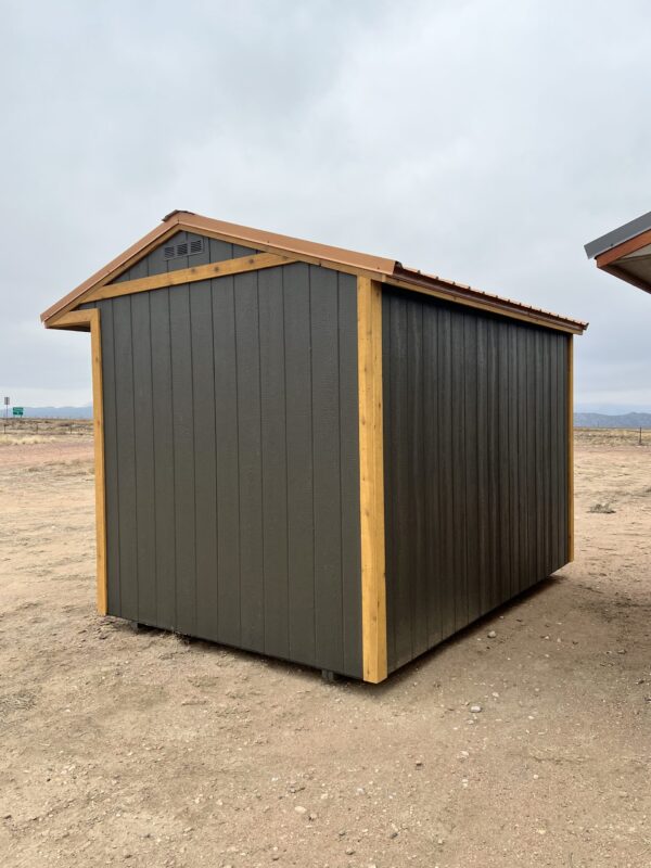 The sky stretches above a wooden shed on the Colorado landscape, with clouds drifting across the outdoor scene.