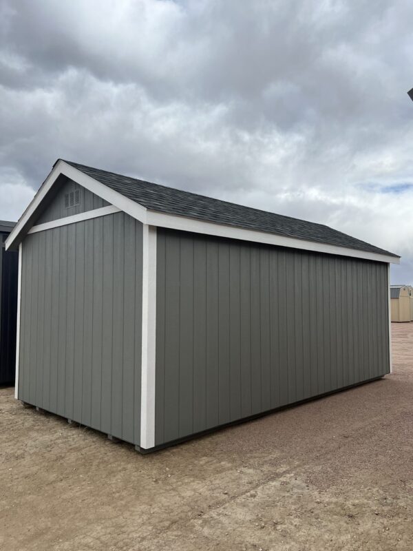 A 10x20 Gable Style storage shed stands on the outdoor property under a cloudy sky.