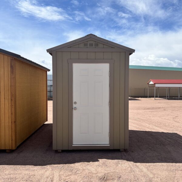 The sky is dotted with clouds as a 6x8 Gable Style storage shed with Interior Finish stands in the foreground.