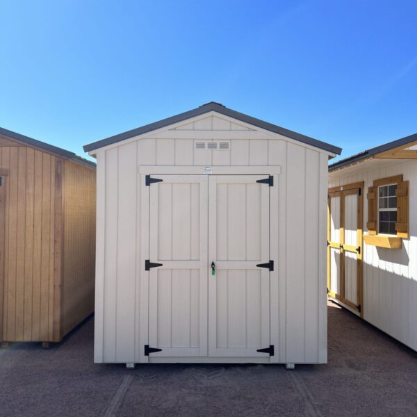 Take in the front view of our 8x14 Gable Style storage shed, revealing its stylish design and attention to detail. The light grey wooden paneling enhances the shed's aesthetic appeal, while the symmetrical lines and proportions create a balanced and pleasing visual impact. This practical storage solution is as visually appealing as it is functional, making it a standout addition to your property.