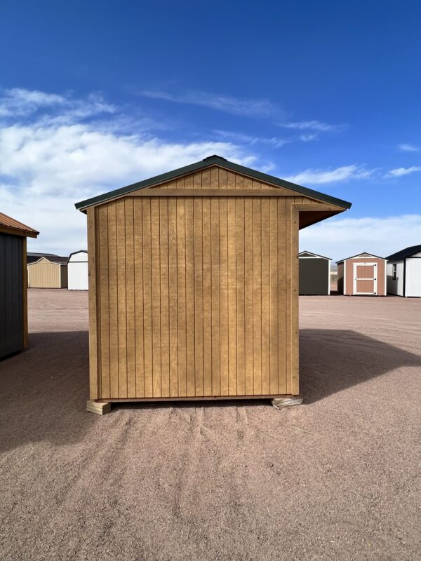 View our brand-new 8x10 Loafing storage shed, captured in a side view that highlights its rich brown wooden paneling and a vibrant green roof with a generous overhang, combining functionality and style in perfect harmony